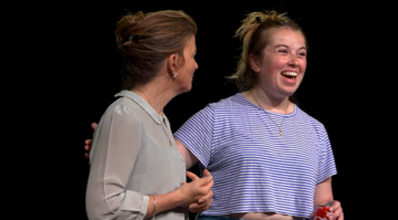 two actors laughing